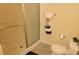 Bathroom with shower and toilet, updated tile flooring at 3621 Amelia Ave, The Villages, FL 32162