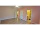 Spacious bedroom with ensuite bathroom access and wood-look floors at 3621 Amelia Ave, The Villages, FL 32162