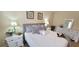 Stylishly decorated bedroom featuring a white comforter, decorative pillows, and matching nightstands at 3621 Amelia Ave, The Villages, FL 32162