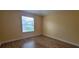 Bedroom featuring wood floors and a bright window offering natural light at 3621 Amelia Ave, The Villages, FL 32162