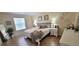 Bedroom boasts neutral walls, wood floors, and a comfortable queen bed with decorative pillows at 3621 Amelia Ave, The Villages, FL 32162
