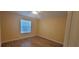 Bright bedroom with wood-look floors and window coverings at 3621 Amelia Ave, The Villages, FL 32162