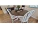 Cozy dining area with a round wooden table and white chairs offers a welcoming space at 3621 Amelia Ave, The Villages, FL 32162