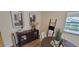 Close-up of the dining area featuring modern art, dark wood cabinet, and elegant decor at 3621 Amelia Ave, The Villages, FL 32162