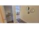 Hallway featuring wood floors leading to a storage closet with wire shelving at 3621 Amelia Ave, The Villages, FL 32162
