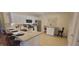 Well-lit kitchen features granite countertops, modern appliances, and an eat-in dining area at 3621 Amelia Ave, The Villages, FL 32162