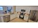 Eat-in kitchen with island, granite countertops and stainless steel appliances at 3621 Amelia Ave, The Villages, FL 32162