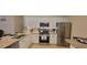 Modern kitchen with stainless steel appliances, granite countertops, and ample cabinet space at 3621 Amelia Ave, The Villages, FL 32162