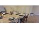 Kitchen with barstool seating, a stainless sink, and a table with chairs at 3621 Amelia Ave, The Villages, FL 32162