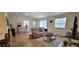 Open concept living room featuring beautiful hard wood floors and natural lighting at 3621 Amelia Ave, The Villages, FL 32162
