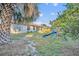 Large backyard with grassy area, palm tree, and playset at 36341 Grand Island Oaks Cir, Grand Island, FL 32735