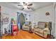 Relaxing Gathering room featuring two comfy armchairs and hardwood floors at 36341 Grand Island Oaks Cir, Grand Island, FL 32735