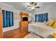 Main bedroom with wood floors and a large TV at 36341 Grand Island Oaks Cir, Grand Island, FL 32735