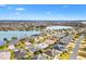 Aerial view showing home's location in a quiet residential neighborhood near a lake at 3962 Neighborly Way, The Villages, FL 32163