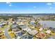 Aerial view showing home's location in a quiet residential neighborhood near a lake at 3962 Neighborly Way, The Villages, FL 32163