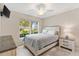 Bedroom with a queen bed, window, and neutral decor at 3962 Neighborly Way, The Villages, FL 32163