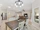 Dining area with wood table and chairs, view into kitchen and living room at 3962 Neighborly Way, The Villages, FL 32163