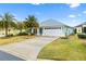 House exterior with landscaping and driveway at 3962 Neighborly Way, The Villages, FL 32163