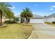 House exterior with palm trees and driveway at 3962 Neighborly Way, The Villages, FL 32163