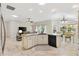 Open kitchen with large island, granite countertops and white cabinets at 3962 Neighborly Way, The Villages, FL 32163