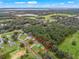 Aerial view of a single-Gathering home on a wooded lot, near a lake at 39727 Redbud Rd, Lady Lake, FL 32159