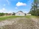 Large backyard with grassy areas and a view of the home's exterior at 39727 Redbud Rd, Lady Lake, FL 32159