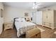 Bedroom with floral bedding and ceiling fan at 39727 Redbud Rd, Lady Lake, FL 32159