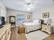 Bedroom with floral bedding and ceiling fan at 39727 Redbud Rd, Lady Lake, FL 32159