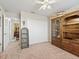 Bedroom with a large wooden armoire, and a view into a hallway bathroom at 39727 Redbud Rd, Lady Lake, FL 32159