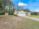 House exterior featuring a two-car garage and a spacious yard at 39727 Redbud Rd, Lady Lake, FL 32159