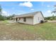 Exterior view of the home, showcasing the side yard and patio at 39727 Redbud Rd, Lady Lake, FL 32159