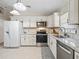 Modern kitchen with white cabinets, granite counters, and stainless steel appliances at 39727 Redbud Rd, Lady Lake, FL 32159