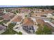 Aerial view of house and neighborhood, highlighting the screened enclosure at 419 Cambio Ct, The Villages, FL 32159