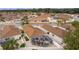 Aerial view of house and neighborhood, highlighting the screened enclosure at 419 Cambio Ct, The Villages, FL 32159