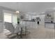 Bright dining area with marble table and modern chairs, adjacent to kitchen at 419 Cambio Ct, The Villages, FL 32159