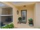 Inviting entryway with a green door and potted plants at 419 Cambio Ct, The Villages, FL 32159