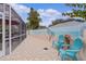 Peaceful patio with beach mural, seating, and potted plants at 419 Cambio Ct, The Villages, FL 32159