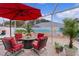 Relaxing patio with red seating, fire pit, and beach mural at 419 Cambio Ct, The Villages, FL 32159