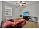 Cozy bedroom with a double bed, dresser, and workspace at 4637 Cragmere Loop, Clermont, FL 34711