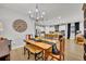 Open concept dining room with kitchen view and rustic farmhouse table at 4637 Cragmere Loop, Clermont, FL 34711