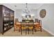 Rustic wooden dining table with six chairs in a bright dining room at 4637 Cragmere Loop, Clermont, FL 34711