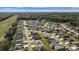 Drone shot highlighting a single-Gathering home in a well-organized neighborhood with lush landscaping at 4654 Ramsell Rd, The Villages, FL 32163