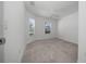 Bedroom featuring neutral walls, plush carpet, and natural light from two windows at 4654 Ramsell Rd, The Villages, FL 32163