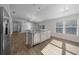 Kitchen island with stainless steel dishwasher and sink, overlooking the living and dining spaces at 4654 Ramsell Rd, The Villages, FL 32163