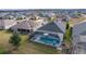 Single-Gathering home with pool and screened enclosure, gray roof, and landscaped yard at 4923 Lawler Loop, The Villages, FL 32163