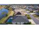 Single-Gathering home with pool and screened enclosure, gray roof, and landscaped yard at 4923 Lawler Loop, The Villages, FL 32163