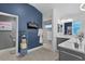 Bathroom featuring blue accent wall, walk-in shower, and double sink vanity at 4923 Lawler Loop, The Villages, FL 32163