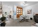 Well-lit dining area with modern table and chairs adjacent to the entryway and a decorative wood wall at 4923 Lawler Loop, The Villages, FL 32163