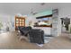 Bright and airy living room with a wood-paneled feature wall and comfortable seating at 4923 Lawler Loop, The Villages, FL 32163