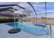 Enclosed pool area with an umbrella, basketball hoop, and views of the lake at 4923 Lawler Loop, The Villages, FL 32163